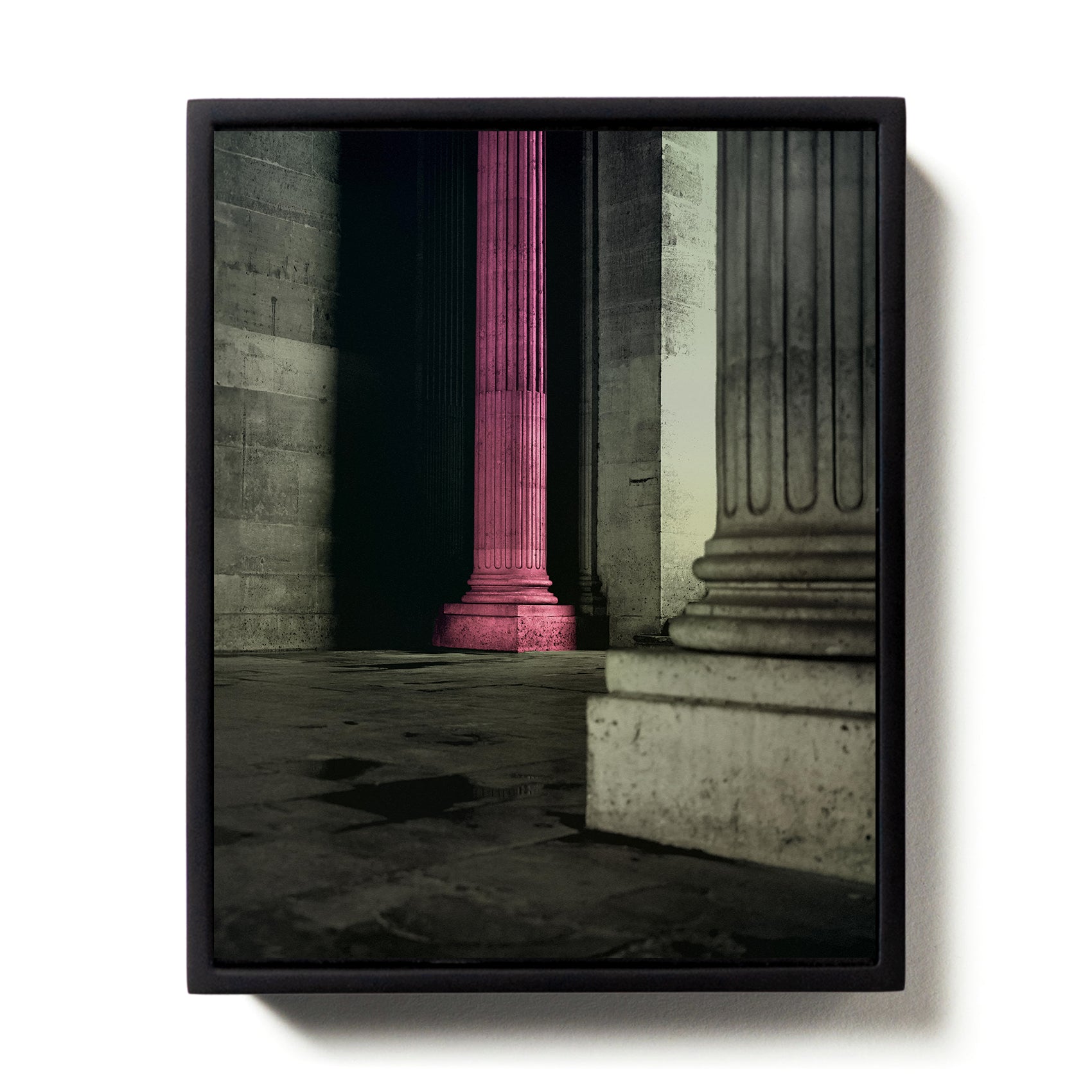 Framed artwork of a classical building interior with a pink column.